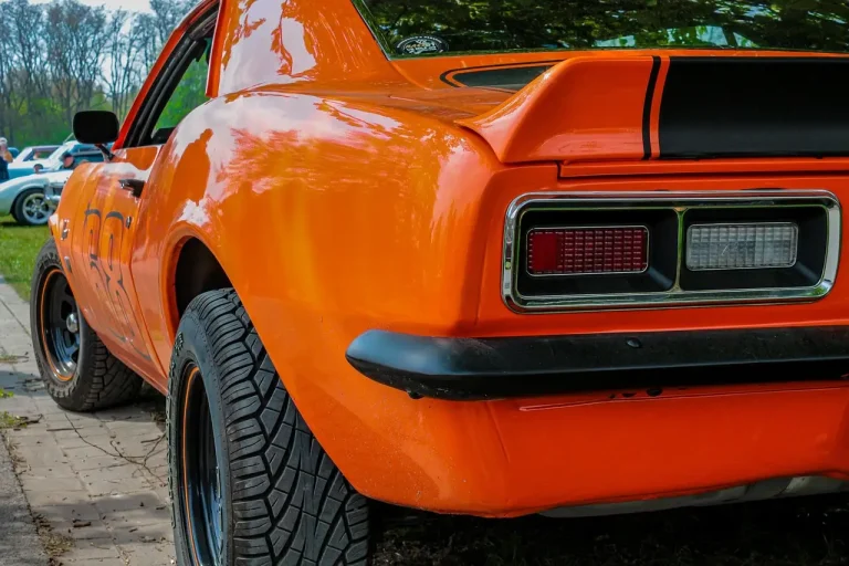 Classic muscle car rear view with polished dual exhaust tips in natural light