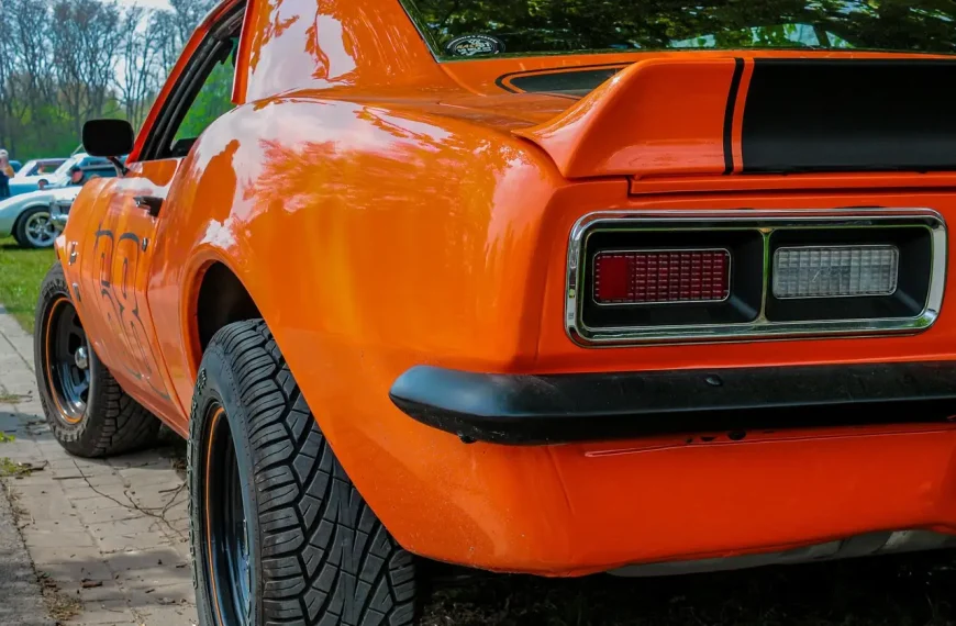 Classic muscle car rear view with polished dual exhaust tips in natural light
