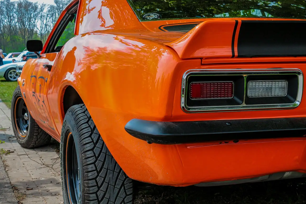 Classic muscle car rear view with polished dual exhaust tips in natural light