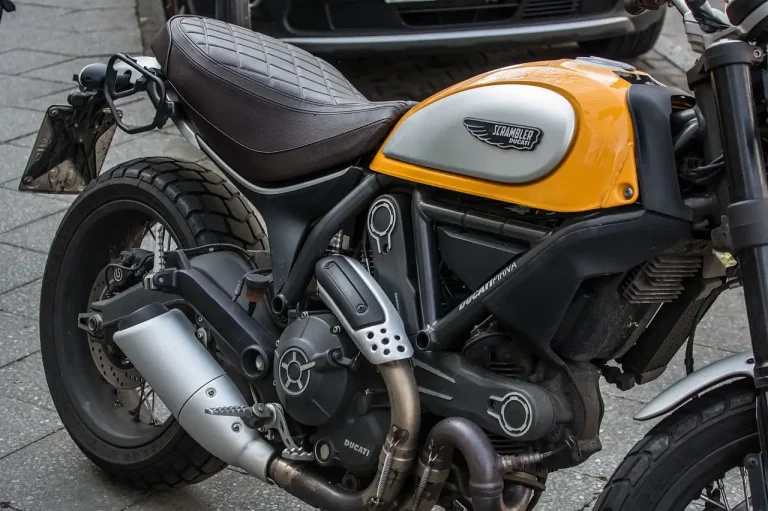 Sport motorcycle with different exhaust tip styles beside it in natural light