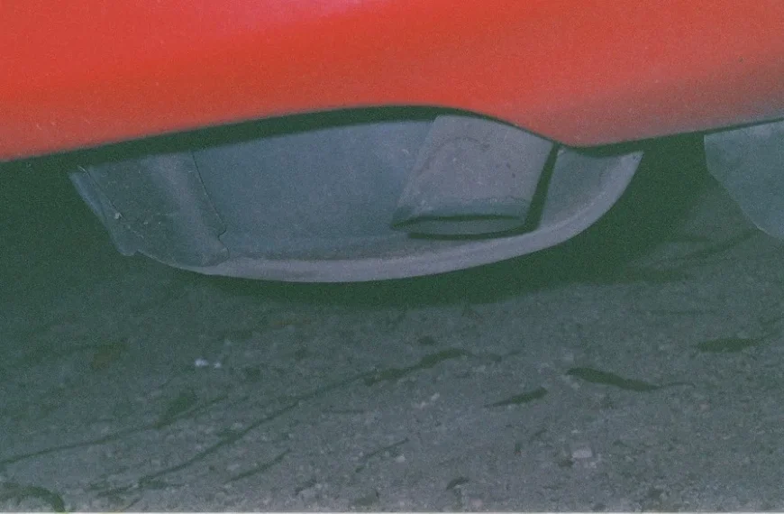 Sports sedan with aftermarket exhaust parked on a suburban road at golden hour