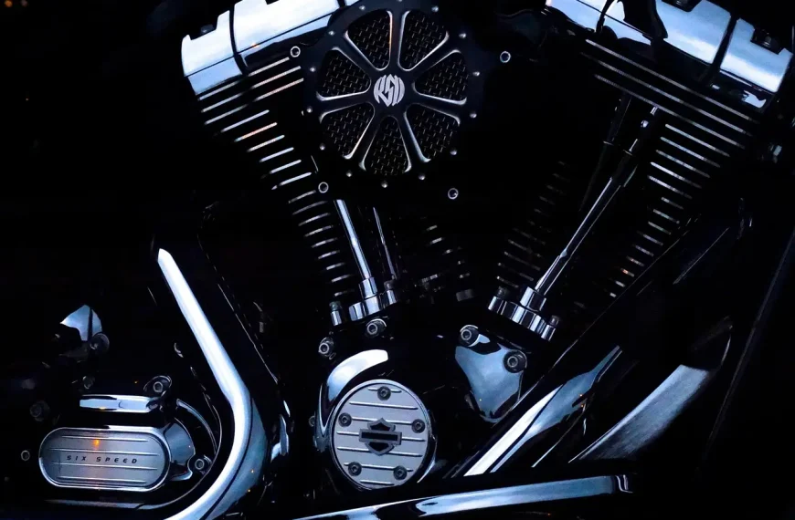 Sport and dual-sport motorcycles with titanium exhausts in a sunlit workshop