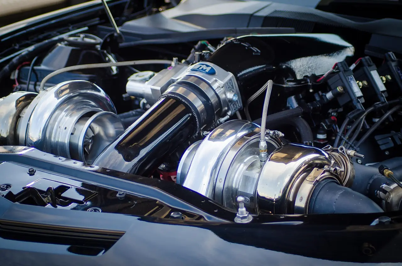 Sports sedan on a lift showing the exhaust path from midsection to rear section in a garage