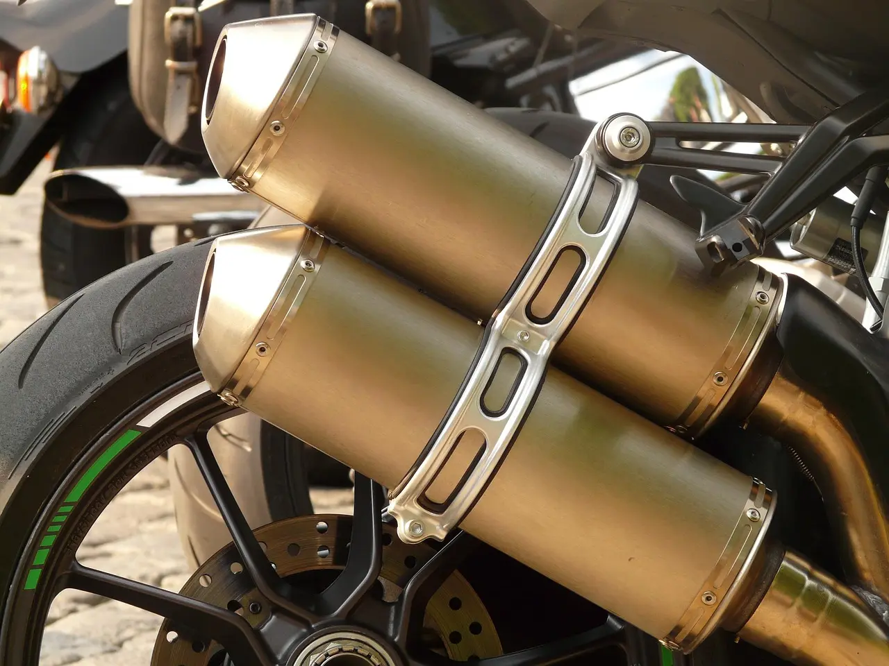 Motorcycle exhaust ceramic coating vs chrome on a parked cruiser in natural sunlight