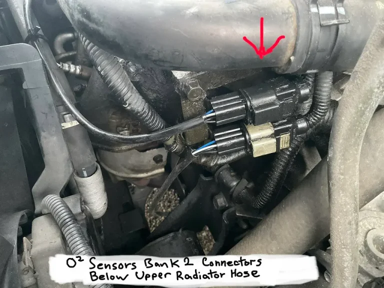 Mechanic tracing an exhaust system beside a car engine, with upstream and downstream oxygen sensor positions visible.
