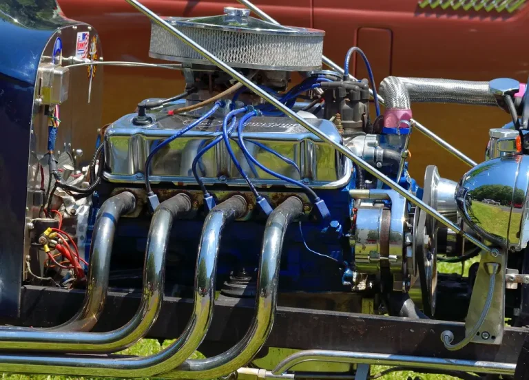 Mechanic comparing exhaust gasket materials beside a car on a garage workbench